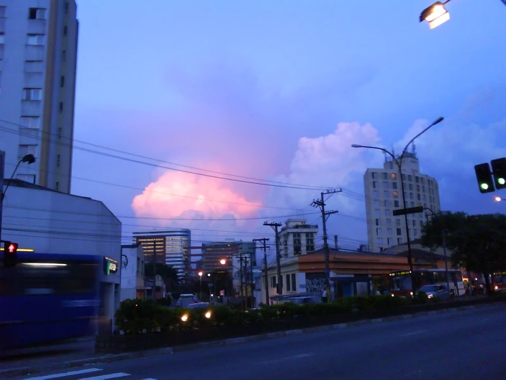 the city is lit up at night by the traffic light