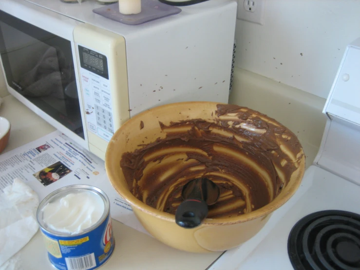 an overhead view of a bowl full of chocolate cake batter