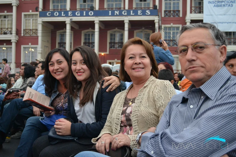 four women and one man are sitting next to each other