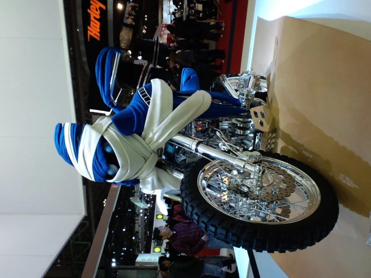 a motorcycle with chrome and blue trim sits on display