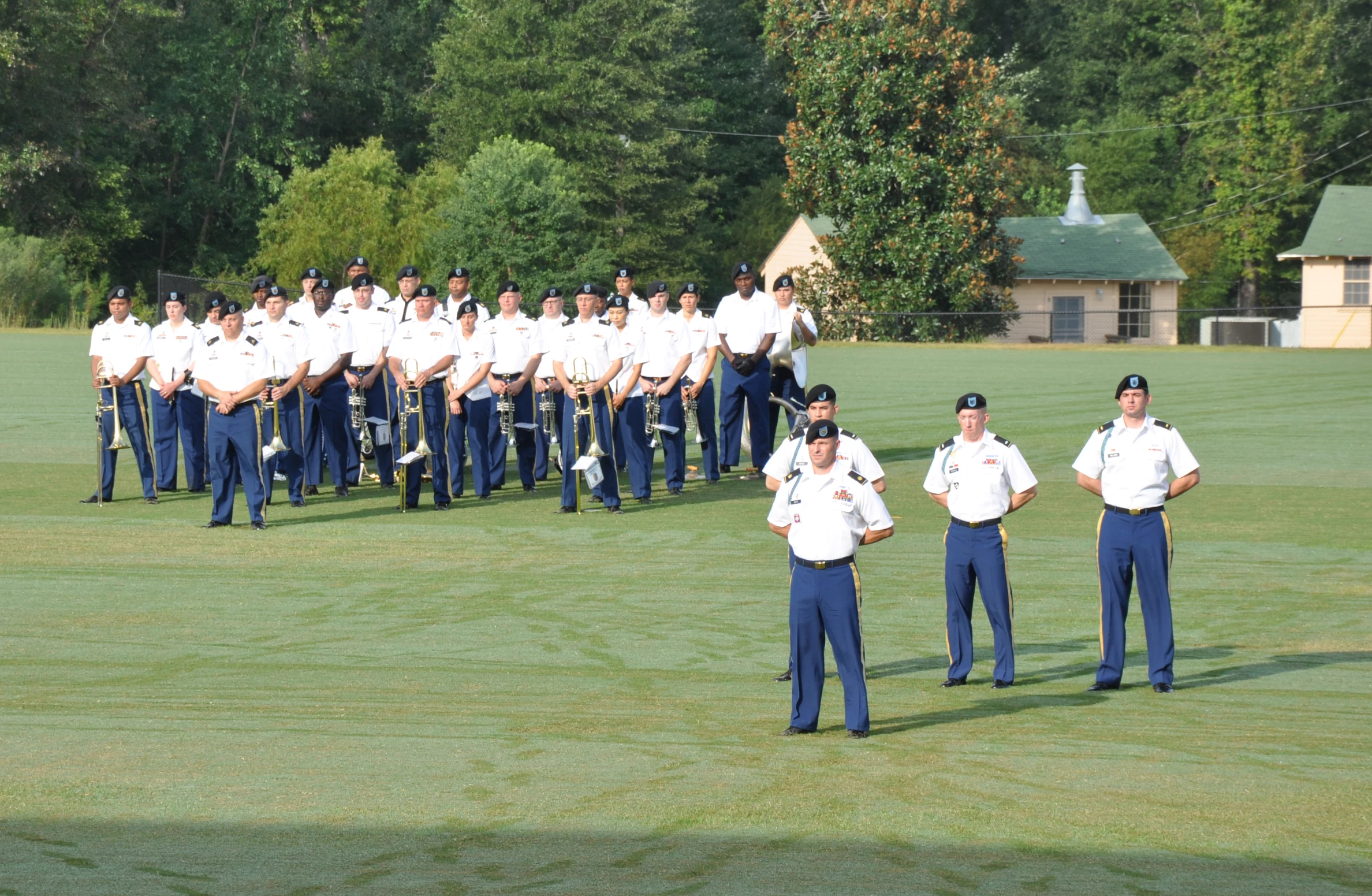 several men stand in uniforms while the man looks on