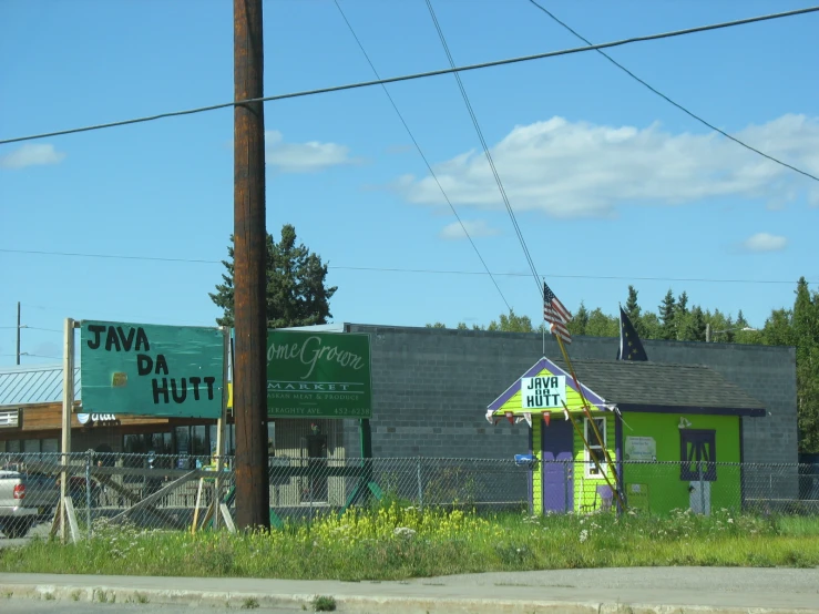 a green and purple building with a sign that says eva hut