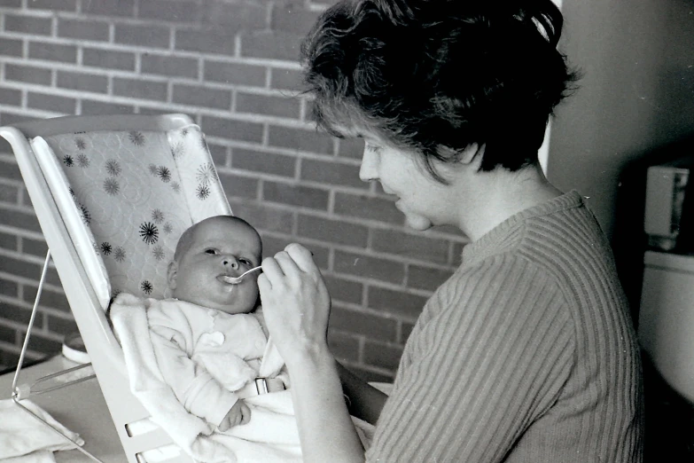 a woman holding a baby in her lap