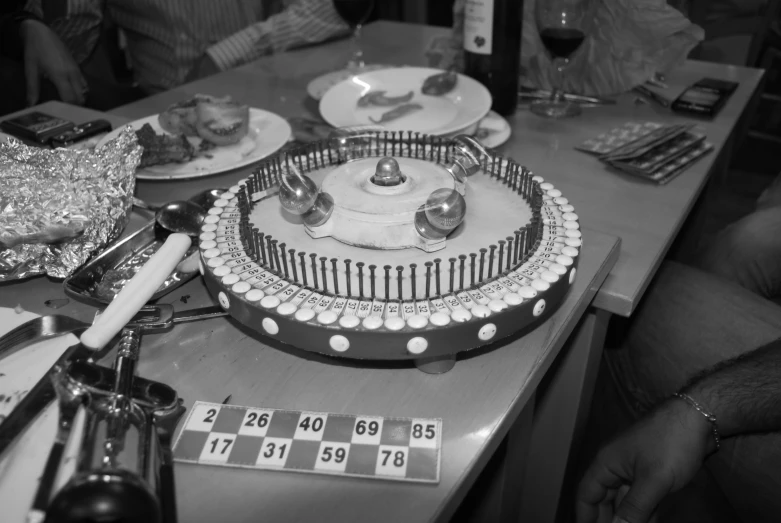 black and white image of dessert on table surrounded by calculator