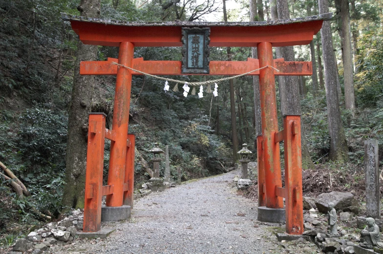 a narrow path under a giant, red wooden shrine