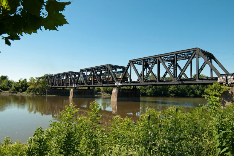 an old railroad bridge over a river