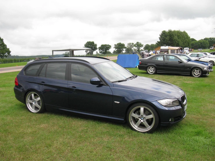 a bmw car is parked on some grass