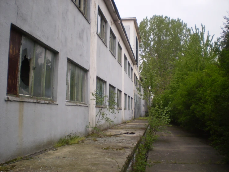 an old rundown building with some broken windows