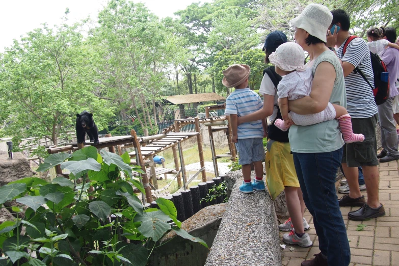 several people are standing in front of a small enclosure