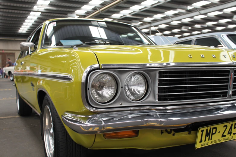 a vintage green car parked in a garage