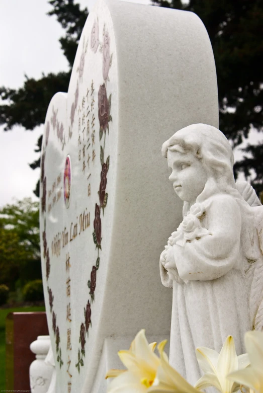 there is a statue of a woman and flowers