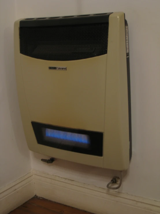 an old bathroom device with thermostaer on