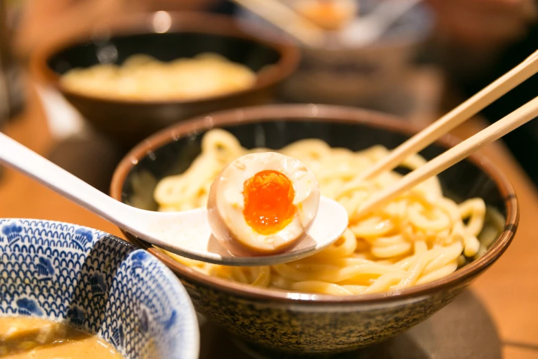 some asian noodles in bowls on a table