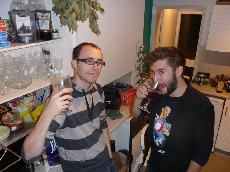 a couple of men drinking glasses of wine