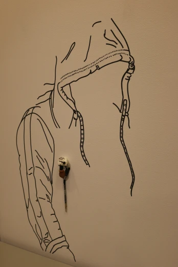 a wall drawing with a screw and a thread attached to it