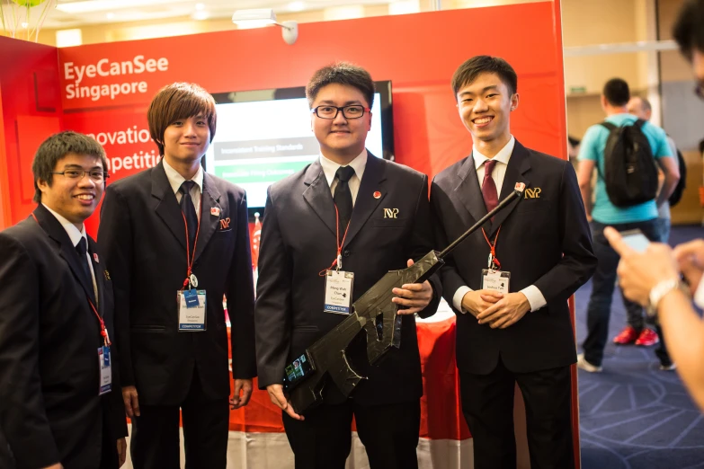 a group of three asian students posing for a po