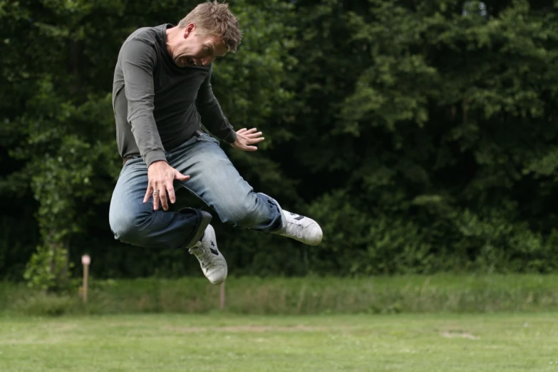 a man jumping to catch a frisbee in mid air