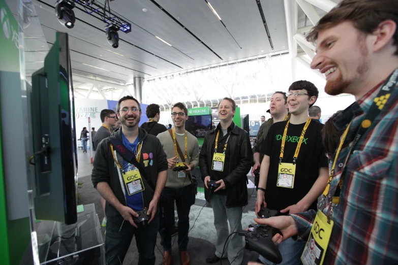 a group of people holding wii controllers standing in a room