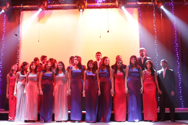 a group of women and men standing on stage