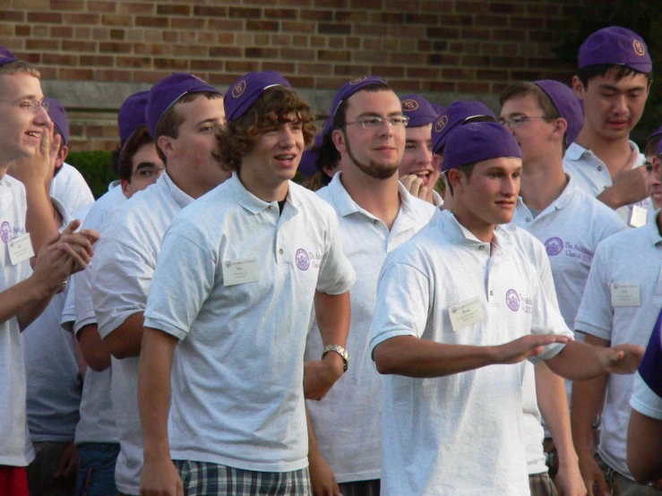 some male tennis players are standing in a row