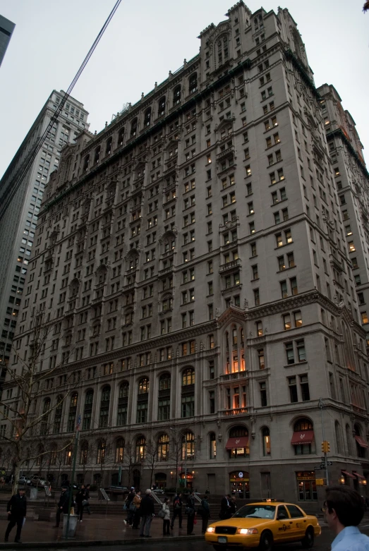 the building has an assortment of windows in the upper floor