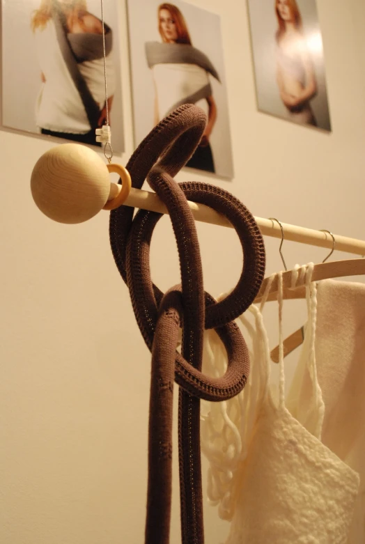a wooden clothes hanger hanging on the wall