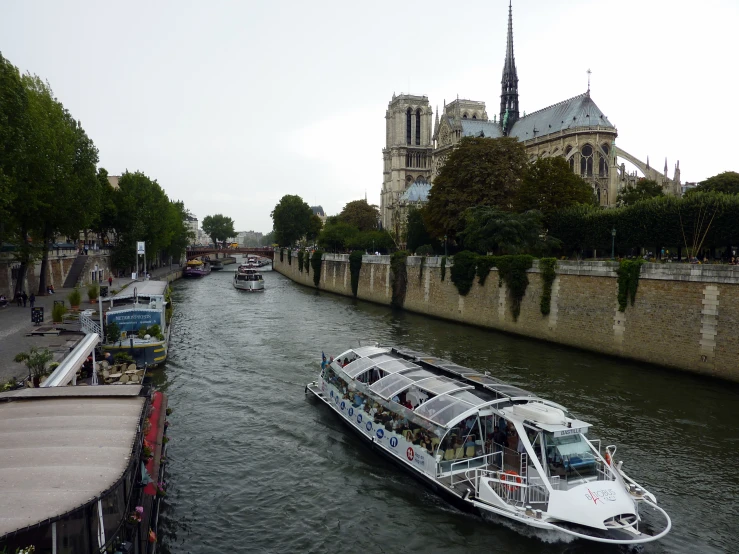 boats traveling along side of each other on the river