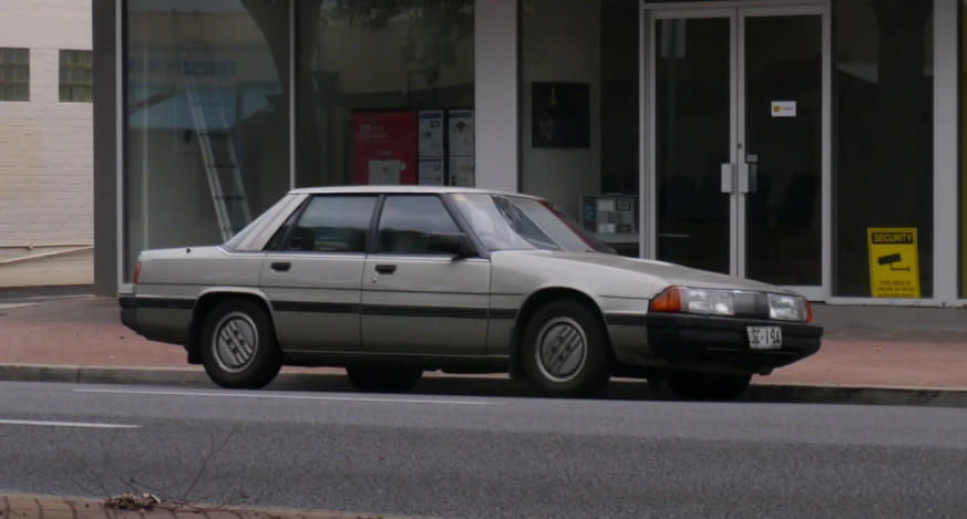 a car parked on the side of the street in front of a building