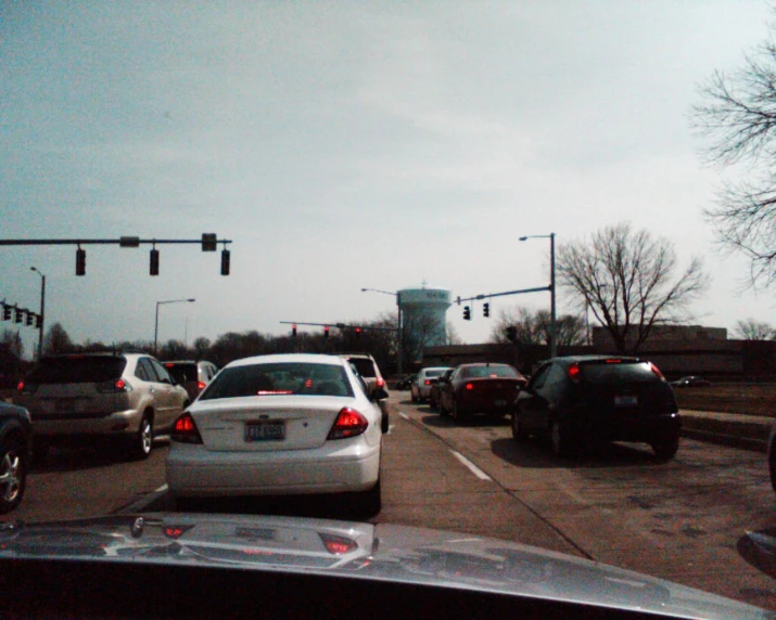 cars stopped at traffic lights as a person drives by