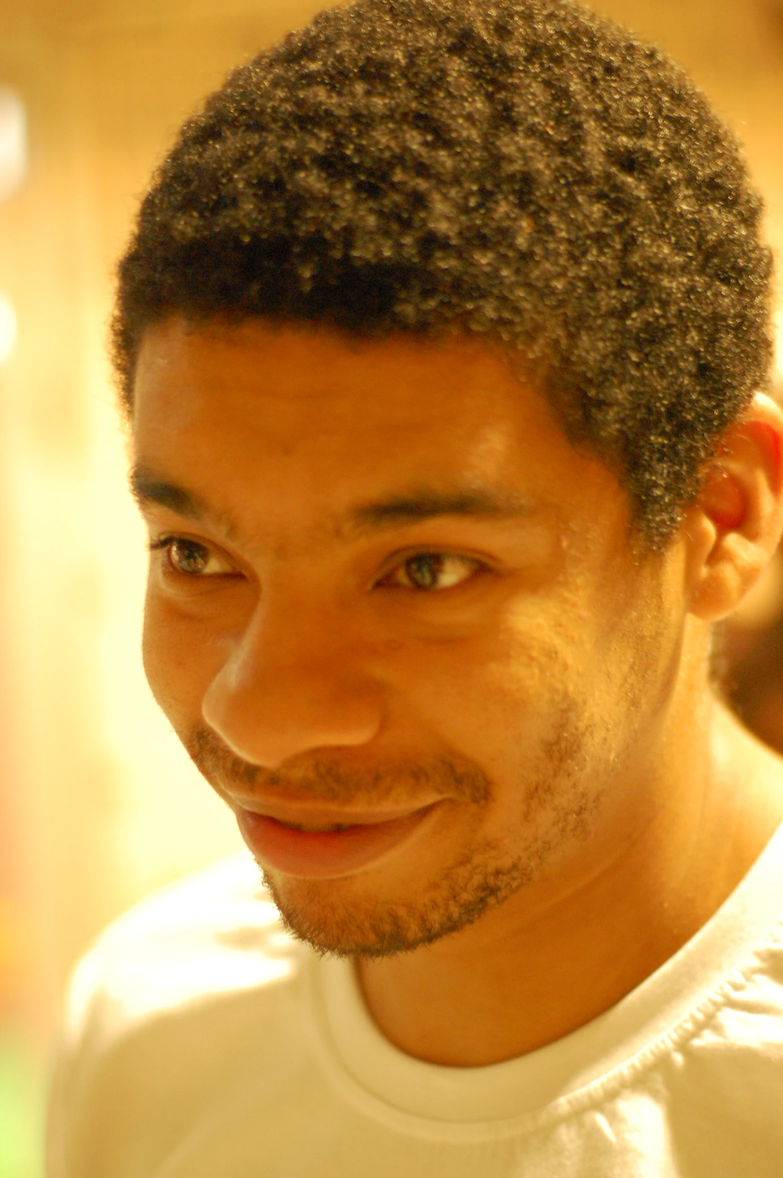 man with large afro standing next to the camera