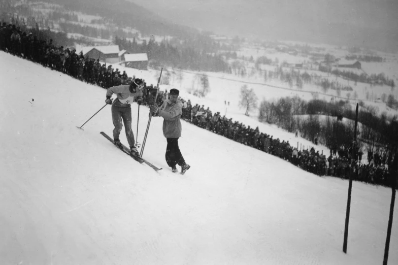 two skiers that are walking in the snow