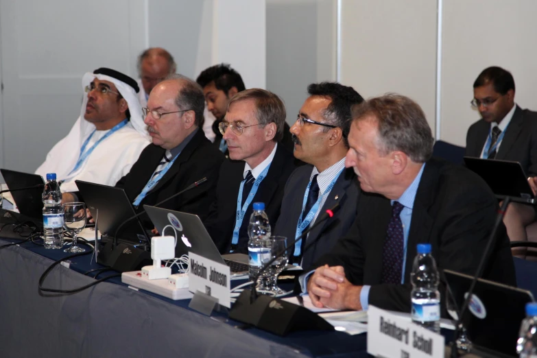 several people are seated in a panel discussion