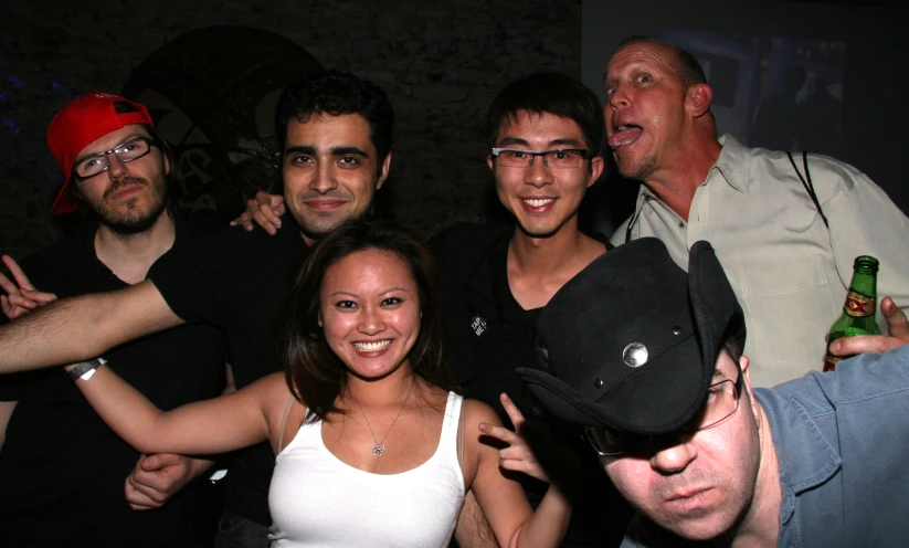 several people posing for a po at a club