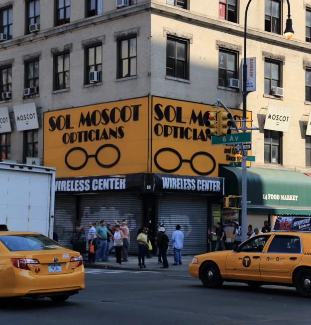 yellow cabs parked in front of a building