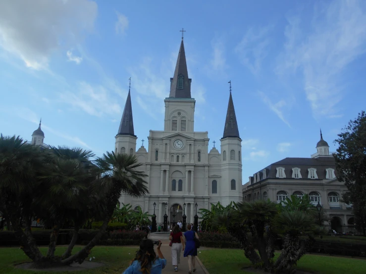 people are walking around an old european cathedral