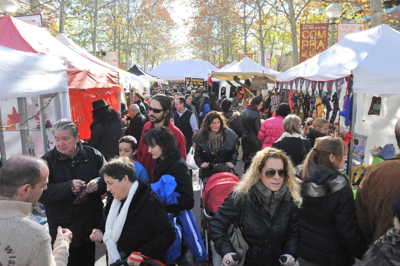 many people walking through the market during autumn