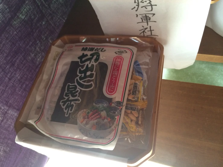 an open take - out box with asian food inside