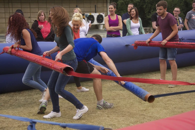 a group of people are playing with two long handled fire rockets