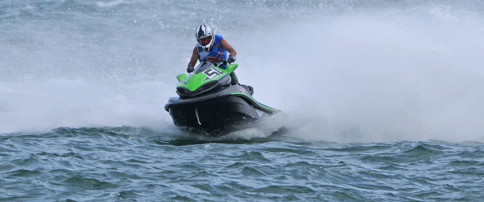 a man riding on a jet ski in the ocean