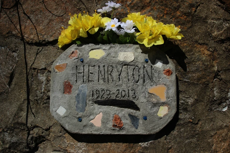 two yellow and white flowers in a memorial