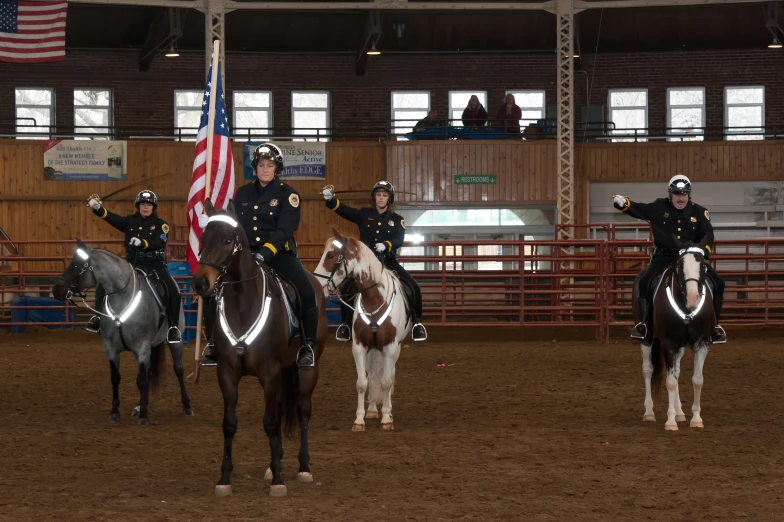 police officers riding horses at the horse show