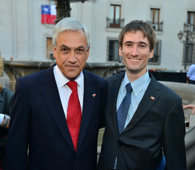 two men in suits and ties standing next to each other