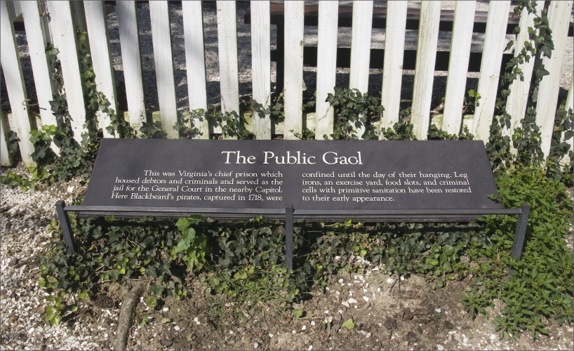 a sign near a fence stating the public god