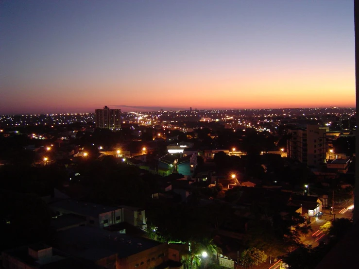 city lights are shown as the sun sets