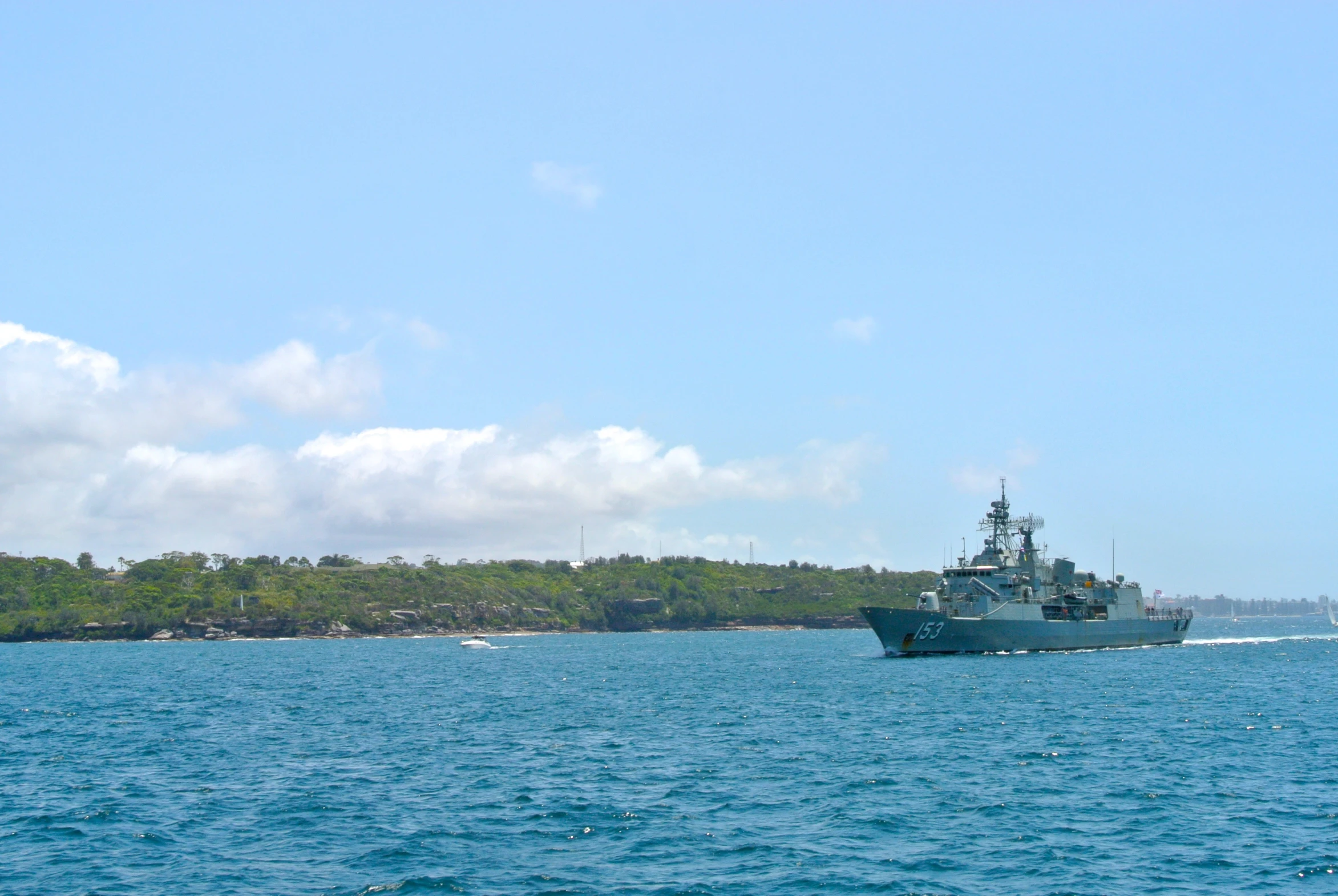 a boat traveling across the open ocean near trees