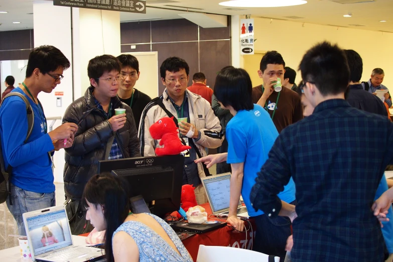 a group of people looking at laptop computers