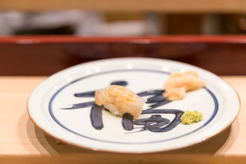 a plate with shrimp on it has a blue and white stripe
