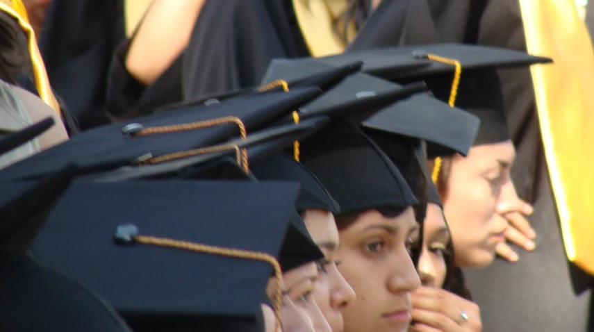 the large group of graduating graduates stand together