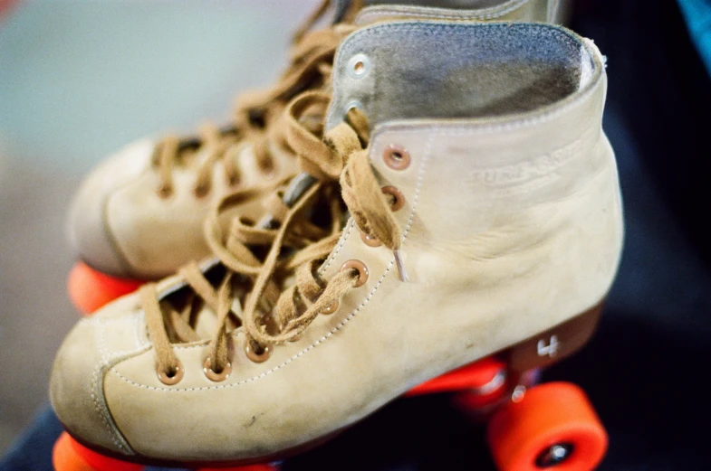 a pair of old roller skates being used by someone