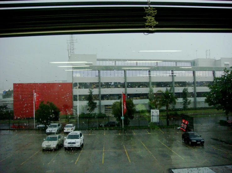 cars parked in a parking lot covered with rain